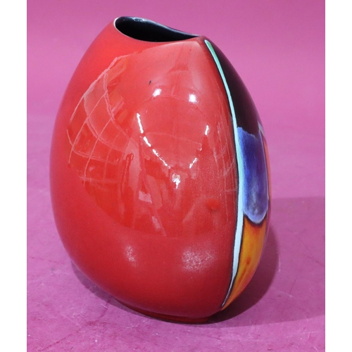 19 - A Poole oval bulbous shaped vase on vibrant red, blue, yellow and orange ground, 19cm high