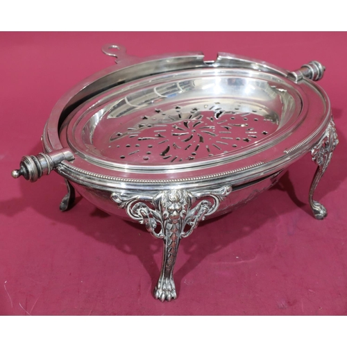 217 - A silver plated oval egg shaped breakfast dish with revolving top enclosing liner on 4 splayed claw ... 