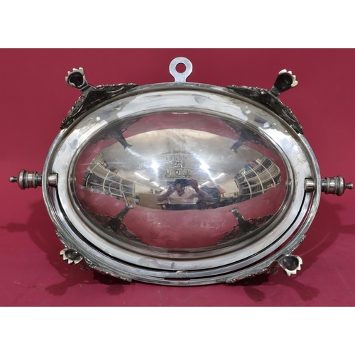 217 - A silver plated oval egg shaped breakfast dish with revolving top enclosing liner on 4 splayed claw ... 