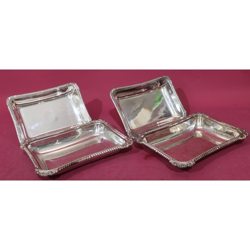 218 - A pair of silver plated rectangular entrée dishes with cover and raised shell, leaf and gadroon rims... 