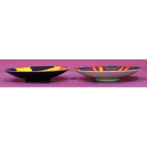 22 - 2 Poole round dishes on vibrant red, blue, orange and black ground, 26.5cm diameter (2)