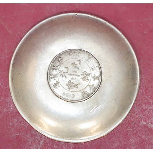 222 - An Oriental silvered circular dish with raised zodiac figures of animals, 10cm diameter