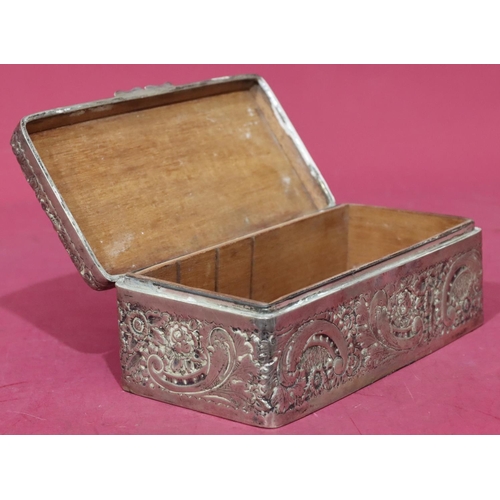 227 - A Victorian silver rectangular shaped cigarette box with allover embossed floral, leaf and scroll de... 