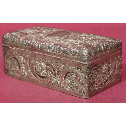 227 - A Victorian silver rectangular shaped cigarette box with allover embossed floral, leaf and scroll de... 