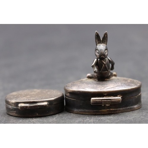 235 - A 925 silver pill box with raised rabbit motif and hinged lid and a silver circular pill box with hi... 