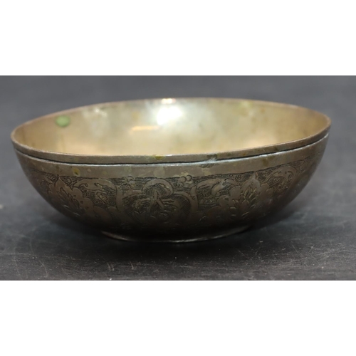 239 - An Eastern silver coloured metal small round bowl inset with a coin and allover engraved floral and ... 