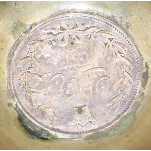 239 - An Eastern silver coloured metal small round bowl inset with a coin and allover engraved floral and ... 