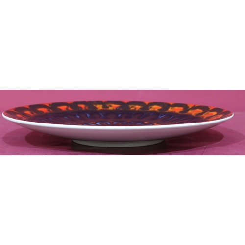 24 - A Poole round charger on vibrant black, blue, orange and red ground, 36.5cm diameter