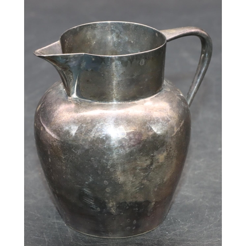 241 - A Sheffield silver round bulbous shaped milk jug, maker's mark HA with engraved crest, 9.8cm high, 4... 