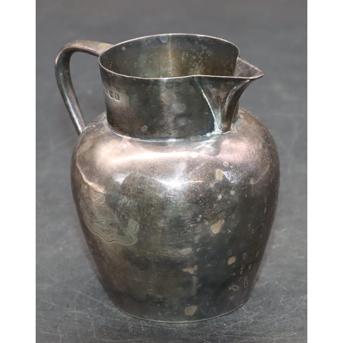 241 - A Sheffield silver round bulbous shaped milk jug, maker's mark HA with engraved crest, 9.8cm high, 4... 