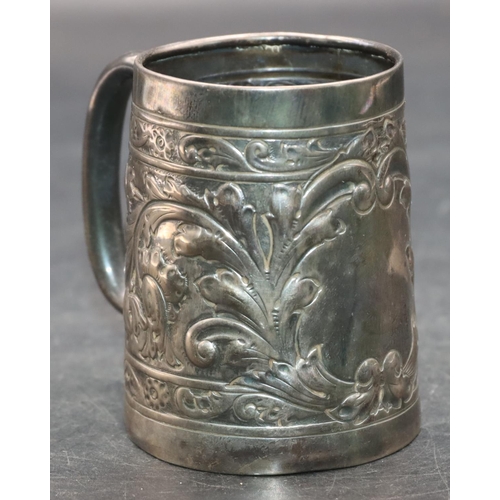 242 - A silver coloured metal christening mug with allover embossed leaf and scroll decoration, 7.2cm high... 