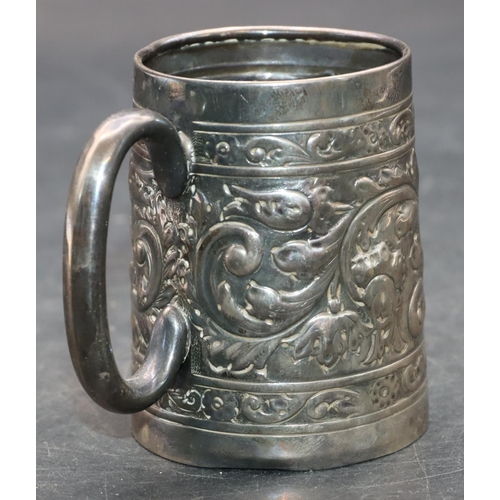 242 - A silver coloured metal christening mug with allover embossed leaf and scroll decoration, 7.2cm high... 