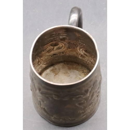 242 - A silver coloured metal christening mug with allover embossed leaf and scroll decoration, 7.2cm high... 