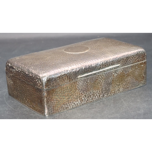 243 - An Edward VII hammered silver rectangular shaped cigarette box with hinged lid enclosing cedar linin... 