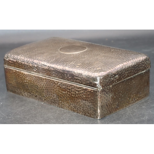 243 - An Edward VII hammered silver rectangular shaped cigarette box with hinged lid enclosing cedar linin... 