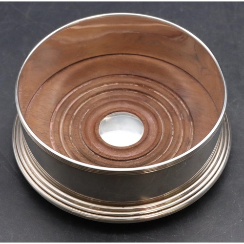 250 - A modern Mappin & Webb, London silver wine coaster with wooden centre, 15cm diameter