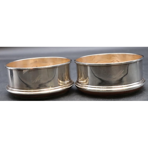 251 - A pair of modern London silver wine coasters with wooden centres, 10cm diameter