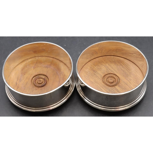 251 - A pair of modern London silver wine coasters with wooden centres, 10cm diameter