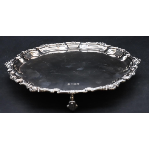 252 - An Elizabeth II silver pie crust card tray with raised shell and scroll rim on 3 splayed scroll feet... 