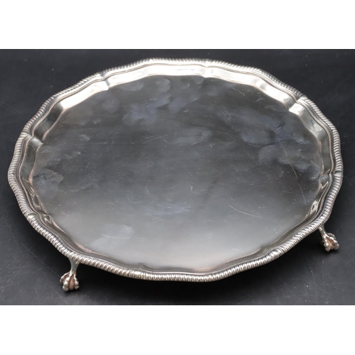 254 - A George VI silver pie crust salver with gadroon rim on 4 splayed claw and ball feet, London 1964, m... 