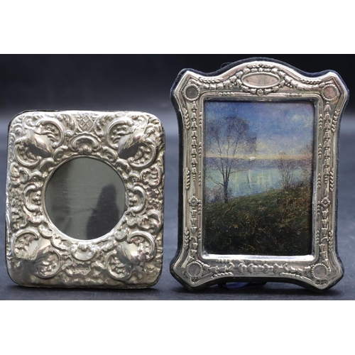 258 - A 925 silver freestanding photograph frame with embossed scroll decoration, 9.7cm high and a London ... 