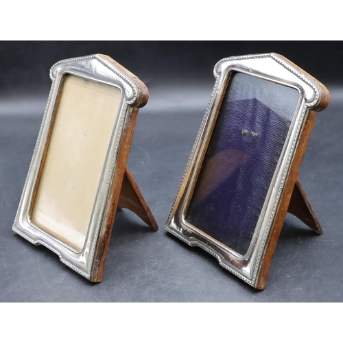 266 - A pair of Birmingham silver freestanding photograph frames with oak backs, 17.5cm high