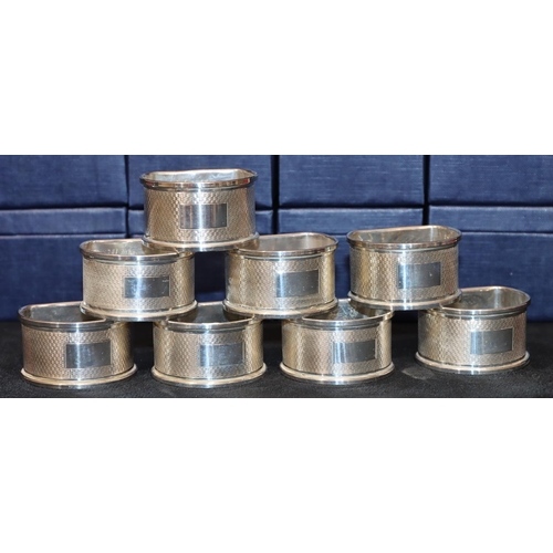 279 - A set of 8 modern Broadway & Co. Birmingham silver half round napkin rings with engine turned decora... 