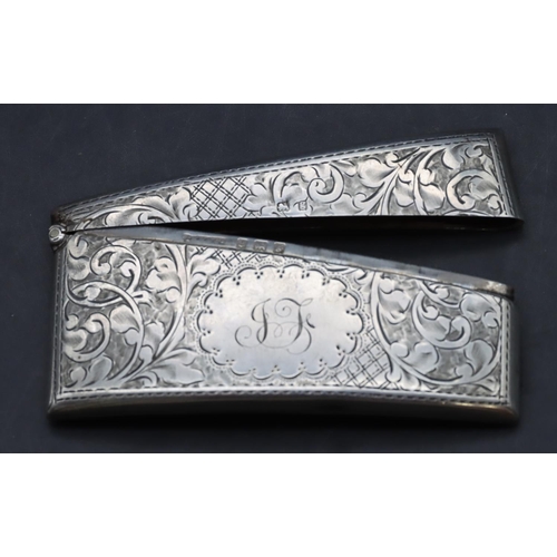 280 - A Birmingham silver concaved shaped card case with hinged top and allover engraved leaf and scroll d... 