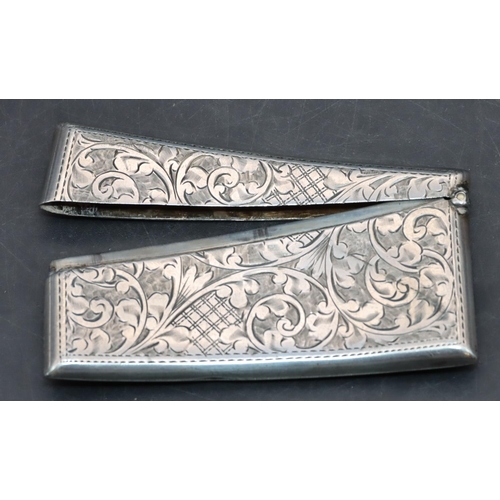 280 - A Birmingham silver concaved shaped card case with hinged top and allover engraved leaf and scroll d... 