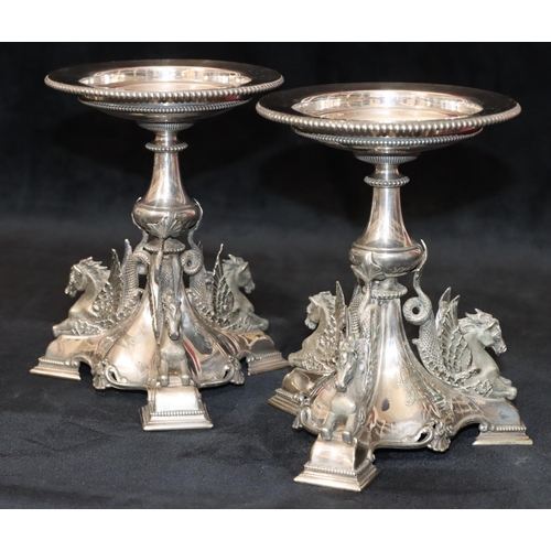 283 - A pair of 19th Century silver plated comport stands on turn stems with raised winged horses on tri-p... 