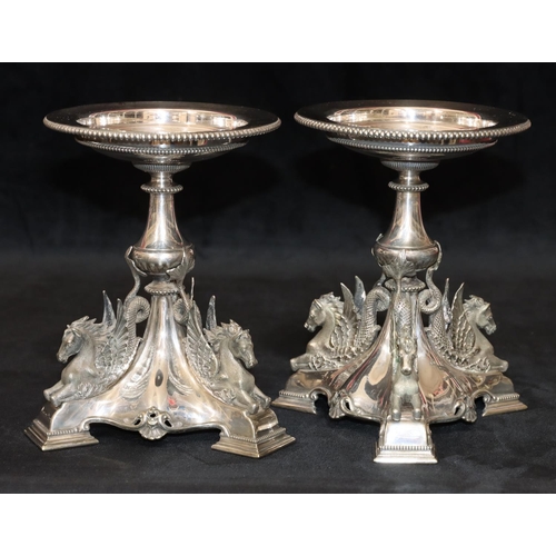 283 - A pair of 19th Century silver plated comport stands on turn stems with raised winged horses on tri-p... 