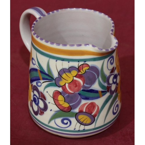 35 - A Poole jug on white ground with multi-coloured decoration, 13cm high, a Poole bulbous thin necked v... 