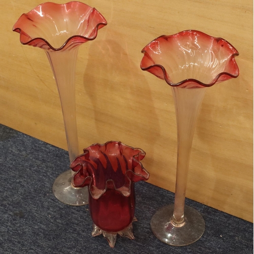 36 - A pair of clear glass and cranberry large round trumpet shaped vases with crinkled rims on round swe... 