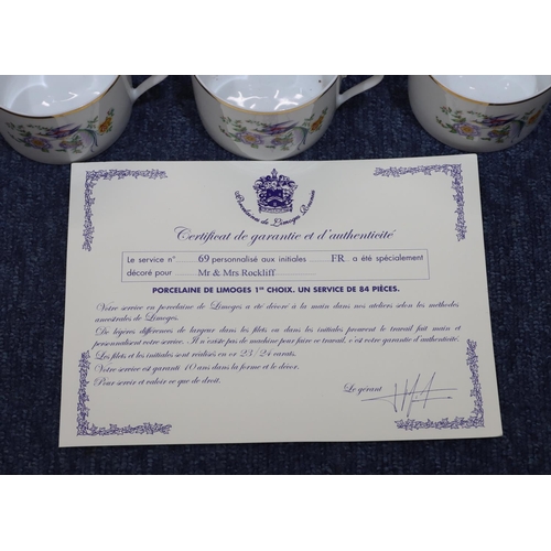 38 - A large Limoges dinner/tea service on white ground with multi-coloured bird, floral and leaf decorat... 