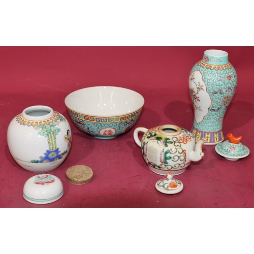 42 - An Oriental small round bulbous shaped teapot with cover and multi-coloured floral, leaf and scroll ... 