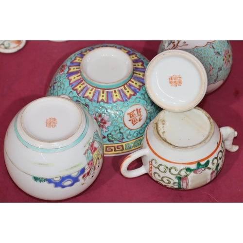 42 - An Oriental small round bulbous shaped teapot with cover and multi-coloured floral, leaf and scroll ... 