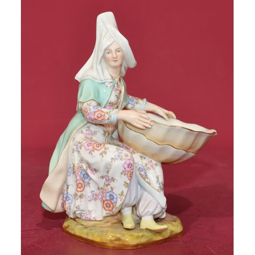 54 - A Meissen salt in the form of a seated young lady holding a shell with multi-coloured floral and lea... 