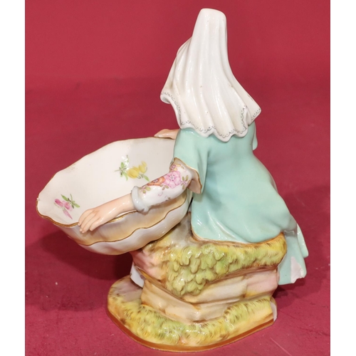 54 - A Meissen salt in the form of a seated young lady holding a shell with multi-coloured floral and lea... 