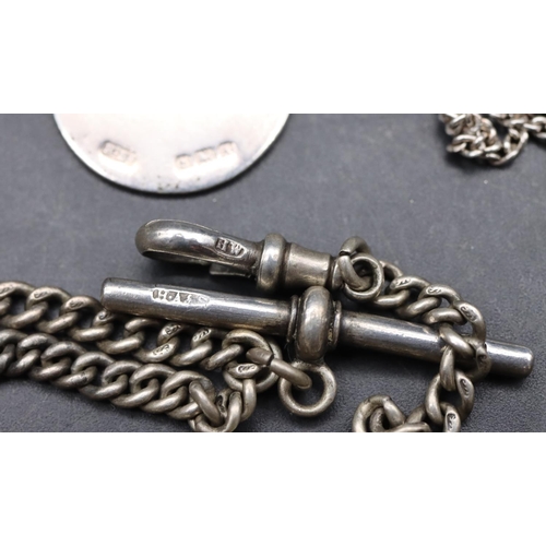 547 - A graduated silver watch chain with T-bar, a silver circular pendant with chain and a Continental si... 