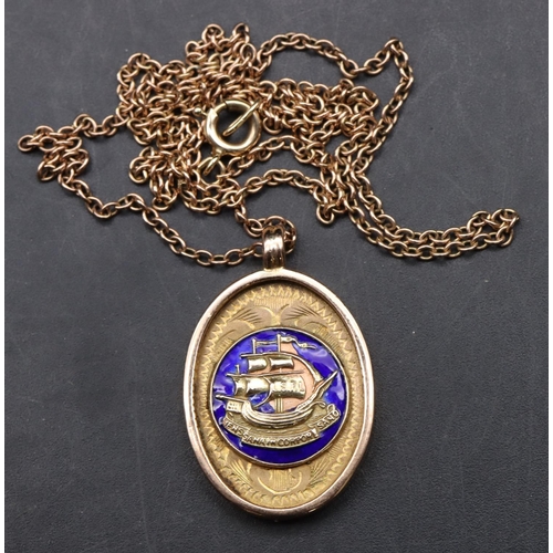 551 - A 9ct gold oval pendant inscribed to reverse, with chain and blue enamelled decoration (part enamel ... 