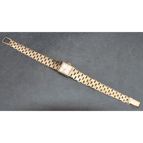 557 - A 9ct gold ladies' Omega square-faced wristwatch with matching strap bracelet, 19.8 grams without mo... 