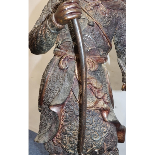 606 - A large bronze figure of a Samurai warrior holding a bow and  young chick on scallop shaped base (bo... 