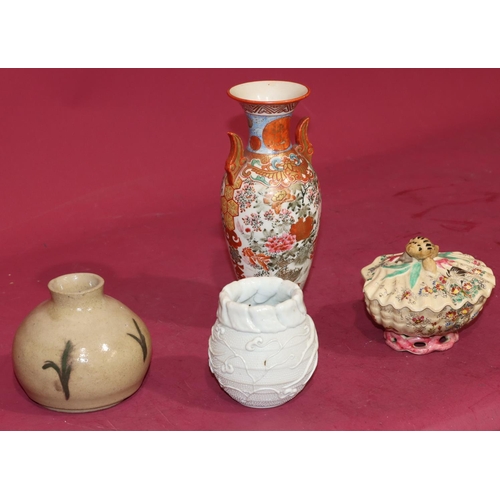 61 - An Oriental round bulbous thin necked 2-handled vase on white and red ground with multi-coloured fig... 