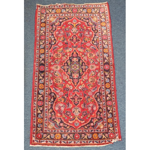 621 - A small Persian style rug on red and blue ground with centre medallion, 138cm x 76cm