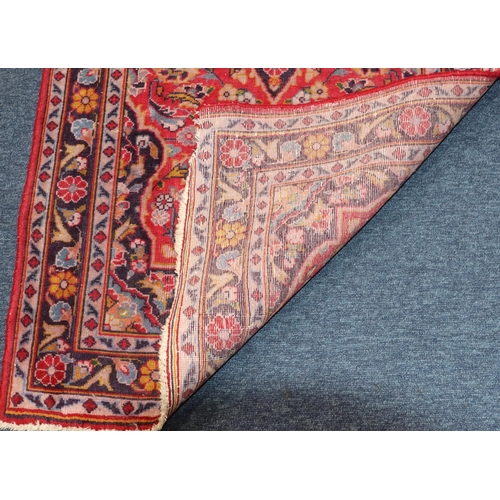 621 - A small Persian style rug on red and blue ground with centre medallion, 138cm x 76cm