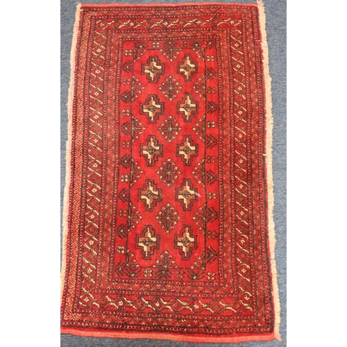 622 - A Balouchi prayer rug on red ground with 2 x 5 centre medallions, 100cm x 56cm