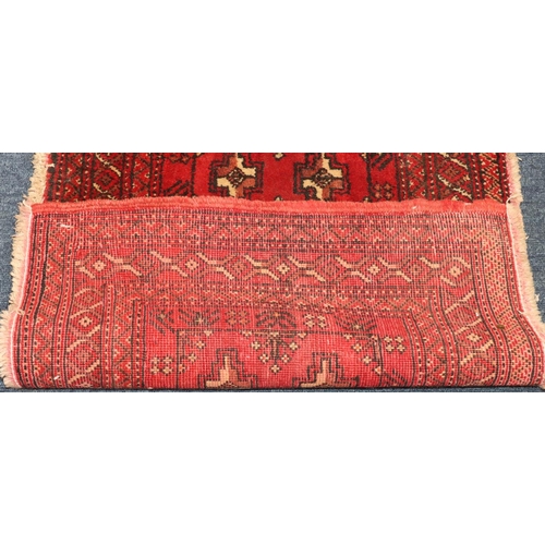 622 - A Balouchi prayer rug on red ground with 2 x 5 centre medallions, 100cm x 56cm