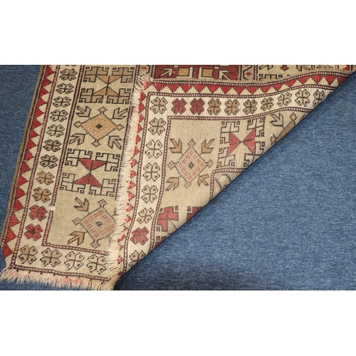 624 - A Persian rug on cream and red ground with centre medallion, 161cm x 94cm