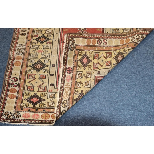 625 - A Persian rug on cream and red ground with shaped centre medallion, 189cm x 123cm