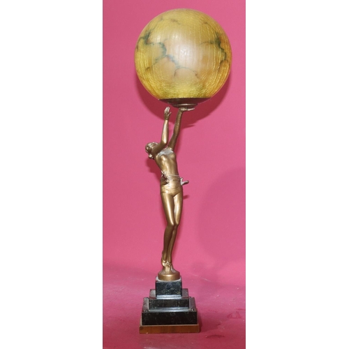 626 - An Art Deco spelter table lamp in the form of a half-naked standing lady holding a circular shade, o... 